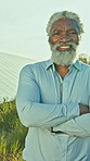 Farm, crossed arms and face of black man with solar panels for renewable energy, sustainability and power. Portrait, engineer and mature person with photovoltaic cell, electricity and environment