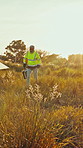 Man, walk and inspection with solar panels in field for renewable energy, electricity and sustainability. Mature, engineer and photovoltaic farm for maintenance, eco friendly power system and sunset