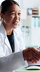 Happy woman, doctor and handshake with patient in hospital, greeting and consultation for healthcare. Office, medical professional and shaking hands with old person, checkup and diagnosis with tablet