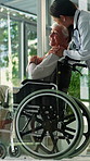 Doctor, old woman and holding hands with wheelchair in house with support, stroke or injury in lounge. Medical professional, talk and senior patient with disability, healing process or rehabilitation