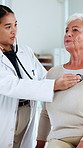 Hospital, stethoscope and doctor with senior woman in consultation, checkup and appointment. Healthcare, listening and person with elderly patient for diagnosis, medical service and heart rate