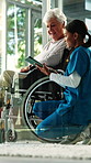 Doctor, old woman and tablet with wheelchair in house with conversation, stroke or injury in lounge. Medical professional, talk and senior patient with disability, healing process or rehabilitation