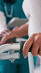 Nurse, hands and senior woman with walker in clinic for consulting, checkup and rehabilitation. Healthcare, hospital and worker on tablet for person with disability for help, support and wellness