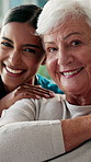 Caregiver, face and hug with old woman in clinic, retirement and support for elderly patient or care. Nurse, portrait and bonding with senior person, embrace and happy for wellness and healthcare