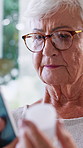 Old woman, phone and pills in home with search for prescription, benefits and glasses in morning. Elderly person, bottle and medicine with smartphone, mobile app and pharma product in retirement