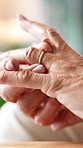 Hands, old woman and nostalgia with ring in home for grief, memory and remember marriage. Mourning widow, senior person and wedding band in retirement for reflection, emotional reminder or loneliness