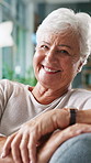 Portrait, elderly woman and relax in home with smile, laugh and calm morning on couch. Confident, senior person and comfortable on sofa for weekend break, rest and happiness in lounge for retirement