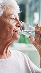 Old woman, drinking water and thinking in home for retirement, reflection and hydration in morning. Elderly person, glass and liquid with detox, electrolytes and wellness with perspective in house