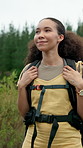 Woman, hiking and travel with backpack in nature for outdoor journey, sightseeing trip or fitness. Active, female person or hiker walking with natural scenery for trekking adventure in wilderness