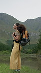 Backpacking, hiking and woman in nature with adventure, discovery or exploring on vacation. Happy, outdoor and person trekking for travel with health, wellness or bonding on holiday or weekend trip.