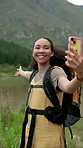 Happy woman, influencer and hiking with video in nature for live recording or streaming. Female person, vlogger or showing natural scenery for outdoor tour of destination, trip or trekking journey