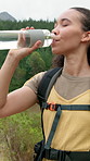 Happy woman, drinking and water with bottle for hiking break, recovery or hydration in nature. Female person, mineral and liquid with smile, beverage or rest for natural sustainability or trekking