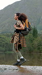 Hiking, holiday and woman on river adventure, sightseeing or backpacker on peaceful break in nature. Backpacking, hiker and African person with smile on vacation, exploring or walk on weekend getaway