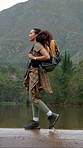 Outdoor, hiking and happy woman on river adventure, travel or explorer on peaceful holiday in nature. Backpacking, hiker and African person with smile on vacation, exploring and walk on weekend break