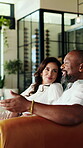 Relax, speaking and couple with smile on couch, funny conversation and laughing for weekend bonding. Chill, gossip and mature people with joke for connection, chat or interracial relationship in home