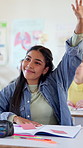 Teenager, girl and answer in classroom with raised hand, learning skills and participation for quiz. Smart, student and talk in high school with knowledge, scholarship or academy for education course
