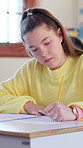 Education, writing and girl with exam in high school for course knowledge, answer quiz or paper. People, teenager or multiple choice test in class for learning evaluation, assessment or questionnaire