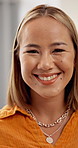 Asian woman, face and smile in home with confidence, pride and laugh in living room on weekend break. Person, happy and portrait in morning, lounge and chill at apartment for rest in Indonesia
