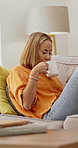 Relax, phone and woman on sofa with coffee for social media, internet and online chat on weekend. Home, happy and person on smartphone for typing message, website and connection with warm drink