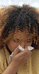 Sneeze, tissue and woman blowing nose on sofa in home with medicine for cold, flu or sinus infection. Illness, virus and female person with toilet paper for allergies or hayfever in living room.