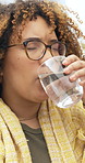 Sick, pills and woman with water on sofa in home with medicine for cold, flu or sinus infection. Illness, virus and female person with box of medication for allergies or hayfever in living room.