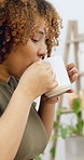 Coffee, relax and woman at desk in home with aroma for caffeine, calm or peaceful on weekend. Cappuccino, remote work and female person drinking warm beverage for freelance career at apartment.
