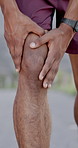 Hands, knee pain and fitness in city with injury in break, rest and stop for tension with exercise in summer. Person, runner and outdoor with joint ache, arthritis or tendinitis on urban street