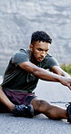 Fitness, man and stretching legs in road for joint mobility, start exercise and cardio preparation. Athlete, male person and muscle warm up outdoor for sports workout, getting ready and body wellness