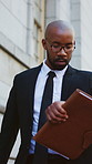 Justice, lawyer and black man in city, check time and late for appointment, commute and folder. Outdoor, African person and attorney paperwork with smart watch, hurry or job opportunity with schedule