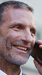 Phone call, smile and businessman in city for communication, contact or networking for finance deal. Happy, cellphone and financial manager on mobile discussion for investment negotiation in town