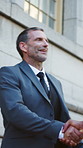 Businessman, meeting and handshake with deal in city for partnership, agreement or onboarding. Man, employees or colleagues shaking hands with b2b for teamwork, greeting or introduction in urban town