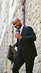 Dancing, lawyer and black man in city with coffee to celebrate court case, success and promotion. Professional, happy and person with energy for good news, victory and legal achievement in town