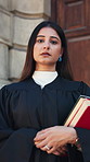 Books, lawyer and face of woman in city with pride for legal career, case study and justice. Government, attorney and portrait of person by courthouse for trial review, legislation and constitution 