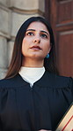 Thinking, lawyer and woman in city with books for legal career, case study and justice. Government, attorney and person with reflection by courthouse for trial review, legislation and constitution 