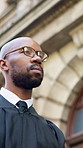 Black man, judge and walk to court in city with books, glasses or legal career for judicial services. African person, magistrate or attorney with law, literature or perspective with low angle in town