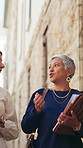 Walking, documents and women in city for meeting, feedback and advice on morning commute. Consultant, trip and worker with assistant for conversation on travel, chat and journey with paperwork