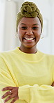 Face, funny and black woman in home, arms crossed and relax with humor, comfort and positive attitude. Happy, laughing and person in lounge, calm morning and satisfaction for weekend break and comic