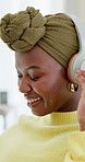 Dance, happy and black woman with headphones on sofa for streaming audio, playlist and album. Home, phone and person with movement listening to music, radio and track for weekend, relax and chill