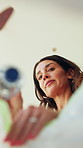Low angle, woman and bottle in trash at house for recycling, cleaning service and environment responsibility. Person, pick up plastic and garbage for hygiene, disposal routine and waste management