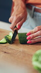 Cooking, meal prep and hands of woman with cucumber for healthy recipe, vegan diet and nutrition. Food, mature person and cut vegetables in home for lunch salad, vegetarian dish and fresh ingredients
