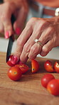 Cooking, meal prep and hands of woman with tomatoes for healthy recipe, vegan diet and nutrition. Food, mature person and cut vegetables in home for lunch salad, vegetarian dish and fresh ingredients