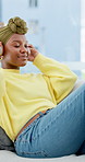 Relax, happy and black woman with headphones on sofa for streaming audio, playlist and album. Home, music and person on couch listening to song, radio and track for calm, unwind and chill on weekend