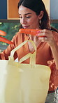 Woman, grocery bag and unpacking with vegetables in home for wellness, healthy food and diet in kitchen. Mature person, package and organic produce for nutrition, ingredients and carrots at house