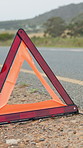 Roadside, warning and triangle for caution outdoor for attention, accident and safety precaution. Danger, sign and hazard symbol for travel emergency, deserted road and signal for traffic control