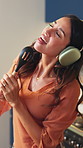 Happy woman, headphones and singing with spoon in kitchen with sound, streaming and song in home. Mature person, voice and rhythm with dance, audio and listen to music with subscription at apartment