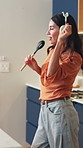 Woman, headphones and singing with dance in kitchen with sound, streaming song and happy in home. Mature person, voice and rhythm with spoon, audio and listen to music with subscription at apartment