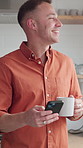 Morning, coffee and happy man with phone in kitchen, laughing and funny message on social media app. Reading, online and person with warm beverage in house, humor and communication with mobile