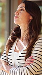 Home, window and woman with arms crossed, thinking and homeowner with thoughts on break or daydream. Future, plan and mature person with serious decision, relax and  reflection on property investment