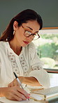 Woman, notebook and writing with remote work from home with computer, review and glasses for proposal. Mature person, virtual assistant and feedback with pc, report and freelance job at apartment