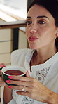 Woman, tea cup and relax with thinking in home with flavor for reflection, memory or break in lounge. Mature person, chill and nostalgia in living room with perspective, beverage and drink in house